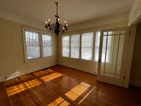 Edmonton apartment for rent - A room with a chandelier and wooden floors.