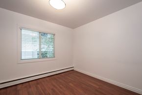 Edmonton apartment for rent - A room with a window and wooden flooring.