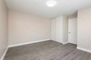 Edmonton apartment for rent - A room with a grey floor and white walls.