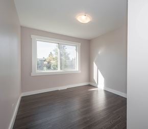 Edmonton townhouse for rent - A room with a window and wooden flooring.