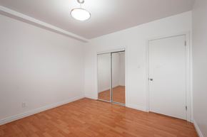 Edmonton apartment for rent - A room with a wooden floor and white walls.
