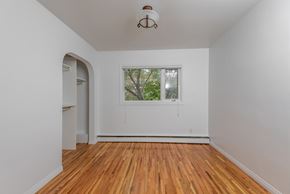 Edmonton apartment for rent - A room with a window and a wooden floor.