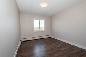 Edmonton apartment for rent - A room with wooden flooring and a window.