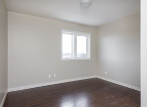 Edmonton apartment for rent - A room with a window and wooden floors.