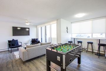 Edmonton apartment for rent - A foosball table sits in the middle of a living room.