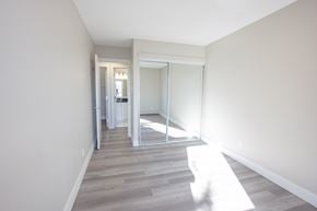 Edmonton apartment for rent - A hallway with a sliding glass door leading to a bedroom.