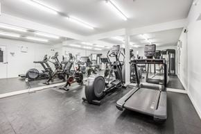Edmonton apartment for rent - A gym with treadmills, exercise bikes, and other equipment.