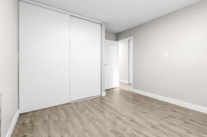Edmonton apartment for rent - A room with a sliding door and wood flooring.