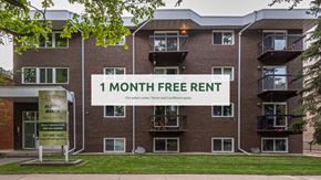 Edmonton apartment for rent - Apartment complex with a sign offering a 1 month free rent.