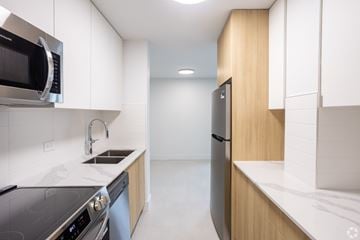 Edmonton apartment for rent - A modern kitchen with a stainless steel oven and microwave.