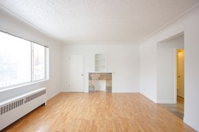 Edmonton apartment for rent - A room with wooden floors and white walls.