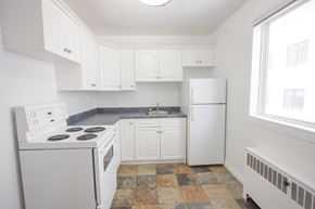 Edmonton apartment for rent - A kitchen with white appliances and cabinets.