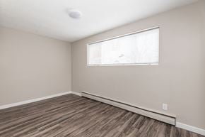 Edmonton apartment for rent - A room with a window and wooden flooring.