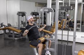 Edmonton apartment for rent - A man is working out in a gym using a machine.