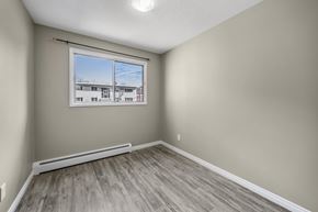 Edmonton apartment for rent - A room with a window showing a view of a building outside.