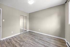 Edmonton apartment for rent - A room with a sliding door and wood flooring.