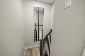 Edmonton apartment for rent - A mirror on the wall above a staircase.