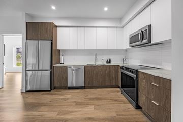 Edmonton apartment for rent - A modern kitchen with wooden cabinets and stainless steel appliances.