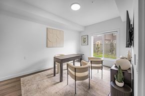 Edmonton apartment for rent - A modern dining room with a table and chairs.