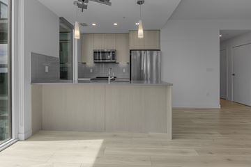 Edmonton apartment for rent - A modern kitchen with a wooden counter and stainless steel appliances.