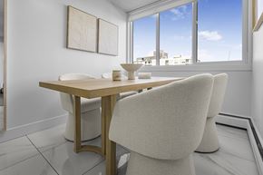 Edmonton apartment for rent - A dining room with a table and chairs.