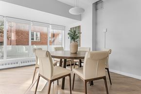 Edmonton apartment for rent - A dining room with a table and chairs.