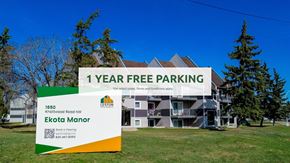 Edmonton apartment for rent - A sign advertising 1 year free parking in front of a building.