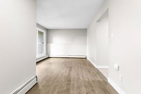 Edmonton apartment for rent - A room with wooden flooring and white walls.