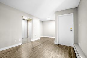 Edmonton apartment for rent - A room with a white door and a mirror on the wall.