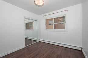 Edmonton apartment for rent - A room with a window and a wooden floor.