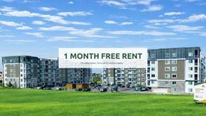 Edmonton apartment for rent - A sign offering a free one month rent is displayed in front of apartment buildings.