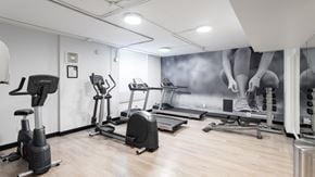 Edmonton apartment for rent - A gym with a variety of exercise equipment including treadmills, stationary bikes, and elliptical machines.