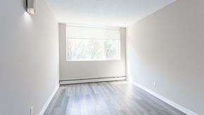 Edmonton apartment for rent - A room with a window and wooden flooring.