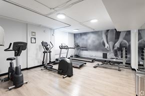 Edmonton apartment for rent - A gym with a variety of exercise equipment including treadmills, stationary bikes, and elliptical machines.