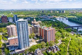 Edmonton apartment for rent - A cityscape with a river and a bridge in the background.