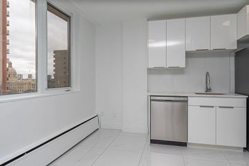 Edmonton apartment for rent - A kitchen with white cabinets and a stainless steel dishwasher.