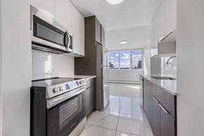Edmonton apartment for rent - A modern kitchen with a white oven and microwave.