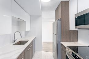 Edmonton apartment for rent - A modern kitchen with a stainless steel oven and white countertops.