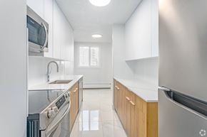 Edmonton apartment for rent - A modern kitchen with stainless steel appliances and wooden cabinets.