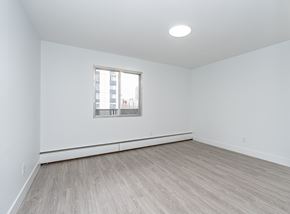 Edmonton apartment for rent - A room with a window and wooden flooring.