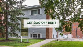Edmonton apartment for rent - A sign offering $500 off rent is displayed in front of a building.