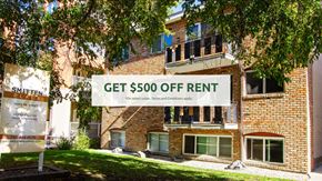 Edmonton apartment for rent - A sign offering $500 off rent is displayed in front of a brick building.