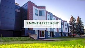 Edmonton apartment for rent - A modern building with a sign offering a free one month rent.