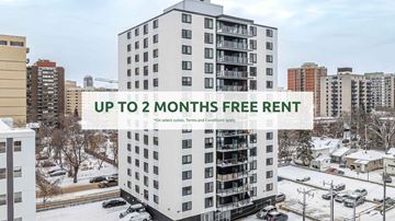 Edmonton apartment for rent - A tall white apartment building with a sign offering up to 2 months free rent.