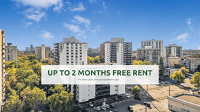 Edmonton apartment for rent - A cityscape with buildings and a sign offering up to 2 months free rent.