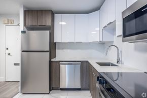Edmonton apartment for rent - A modern kitchen with a stainless steel refrigerator and a dishwasher.