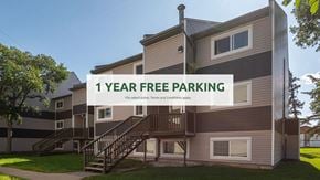 Edmonton apartment for rent - A building with a sign offering 1 year free parking.