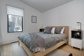 Orillia apartment for rent - A bedroom with a bed, nightstand, and window at The Grove Apartments, Ontario