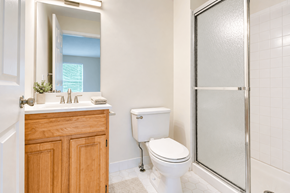Lakewood apartment for rent - A white toilet sits next to a white sink in a bathroom.
