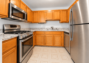 Lakewood apartment for rent - A kitchen with wooden cabinets and stainless steel appliances.